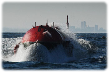 One of three Pelamis machines bursts through a wave at the Aguçadoura Wave Park off Portugal. Image from Wikipedia